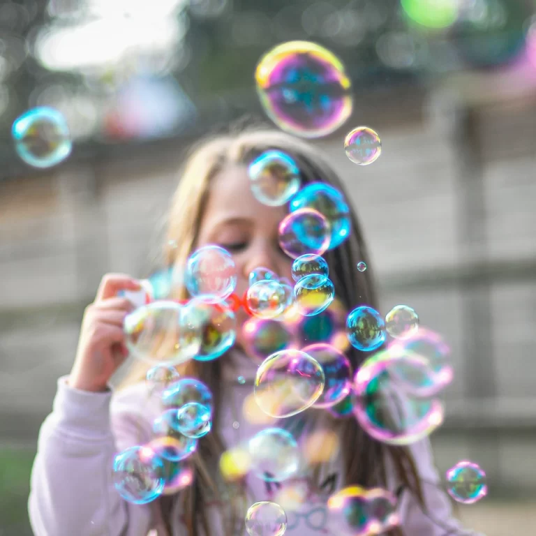 girl blowing bubbles